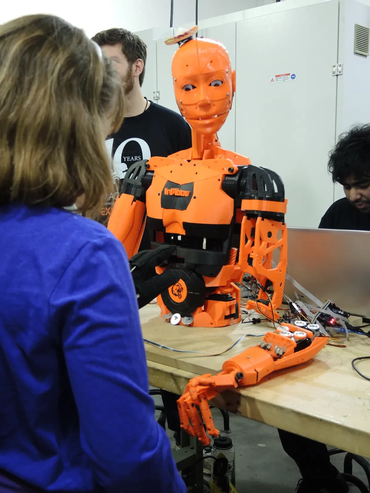 Visitor experimenting with an InMoov 3D-printed robot at Imagine RIT 2017